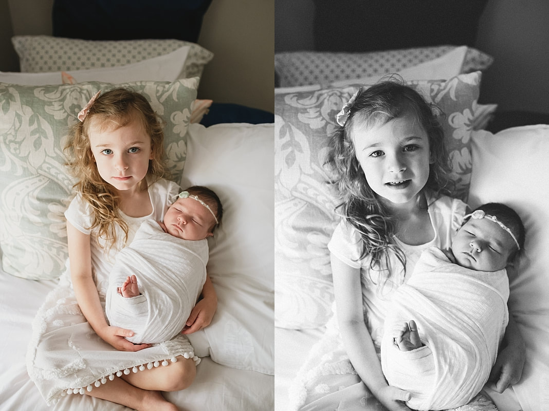 big sister holding newborn baby sister at newborn session in memphis, tn