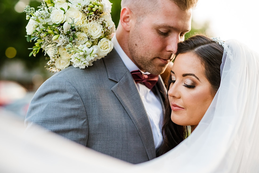 Bride and groom snuggled up during wedding portraits at The Gin in Nesbit, MS