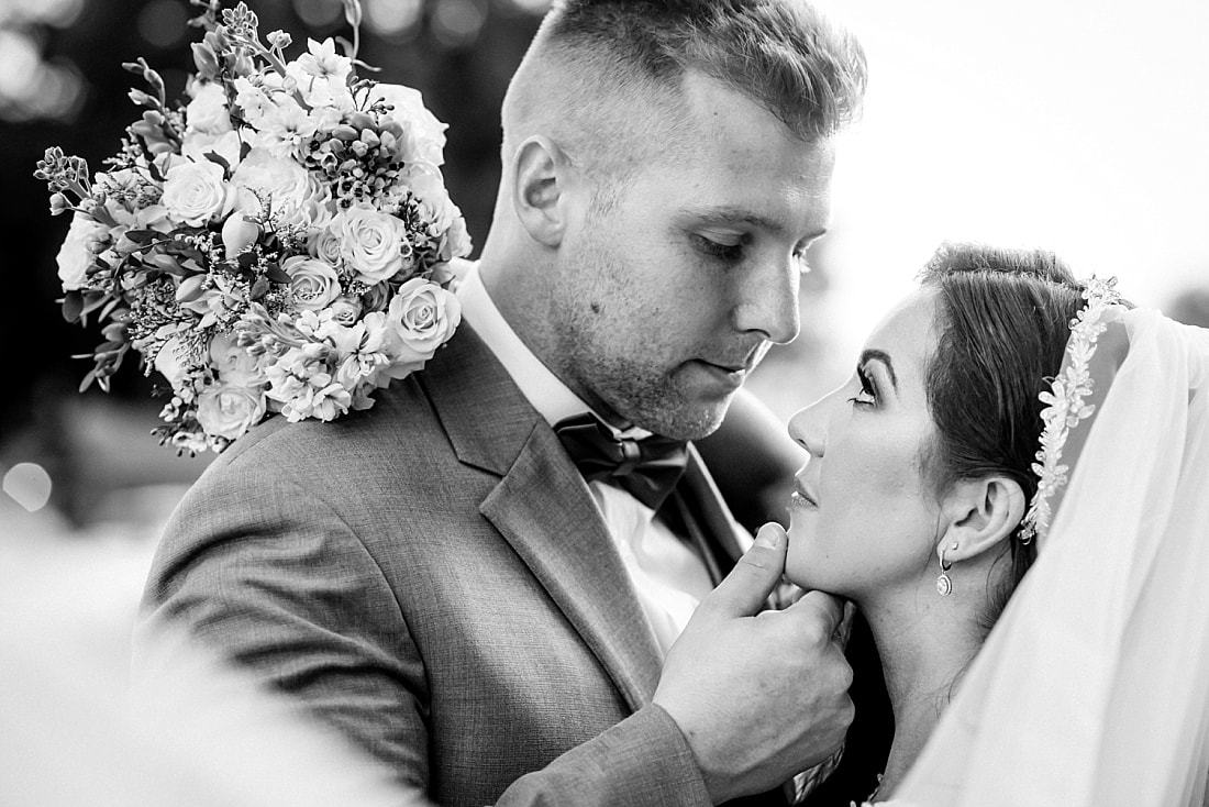 Groom bringing bride in for a kiss at The Gin in Nesbit