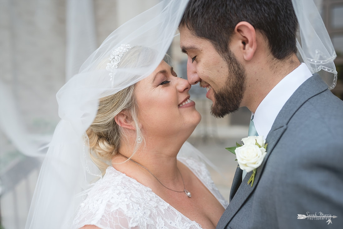 Bride and Groom under wedding veil at Annunciation Greek Orthodox Church in Memphis, TN