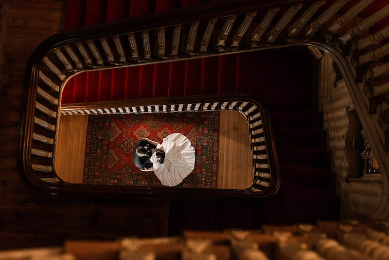 Bride and groom posing at the bottom of the spiral staircase at Woodruff Fontaine during wedding photos with Sarah Morris Photography